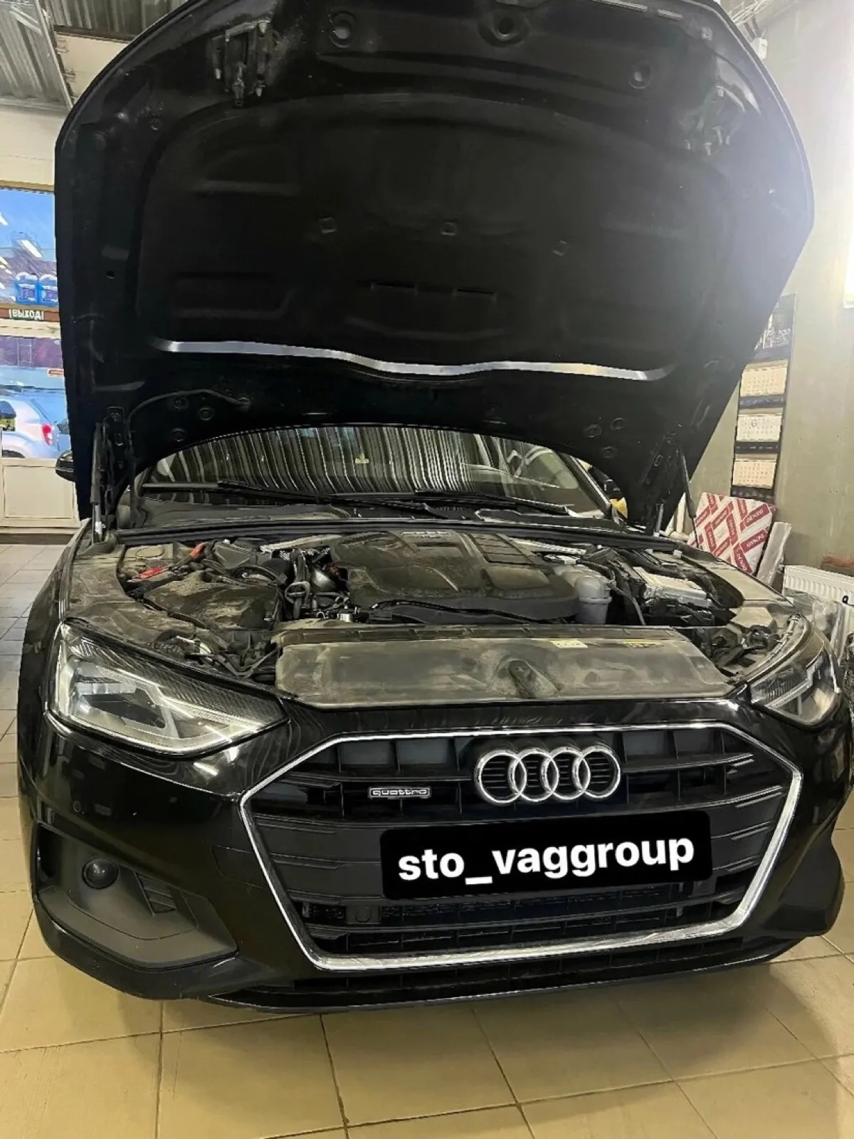Audi A4 с открытым капотом на плановом обслуживании в Vag Group